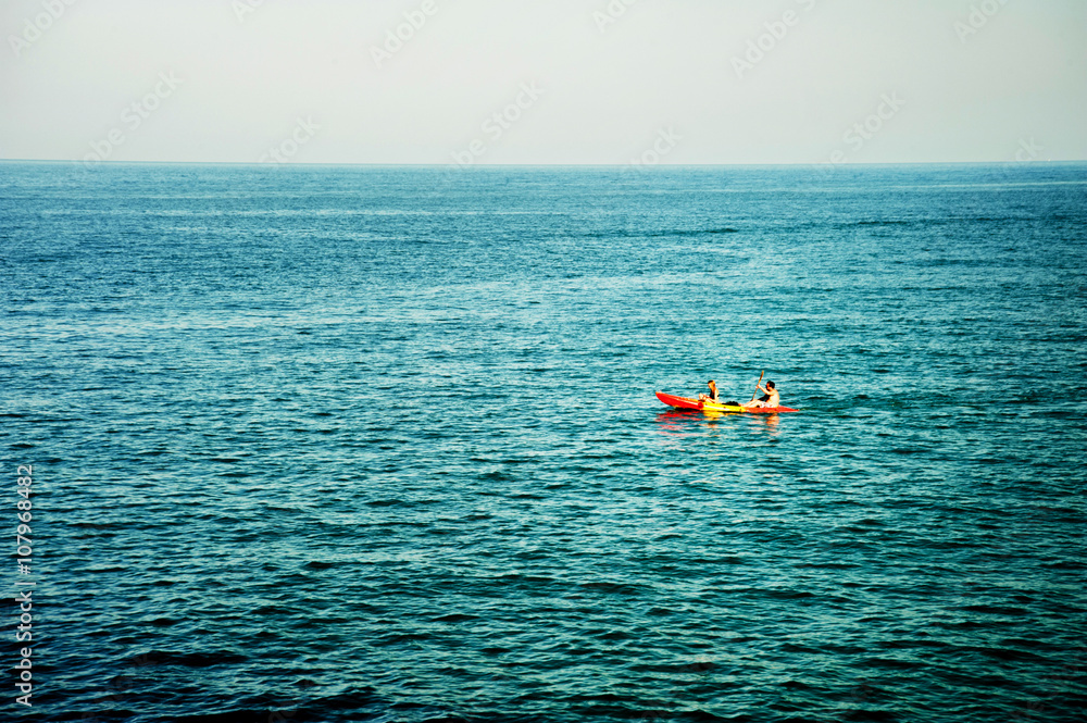 Tourists kayaking in the sea 