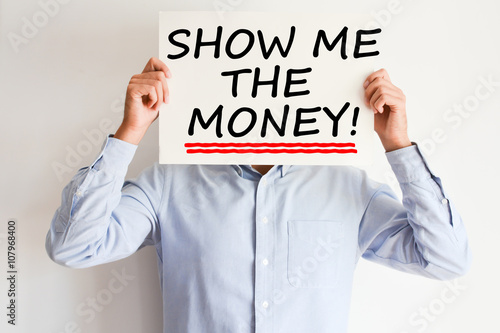 Show me the money text written on paper card suggesting employee success bonus payment