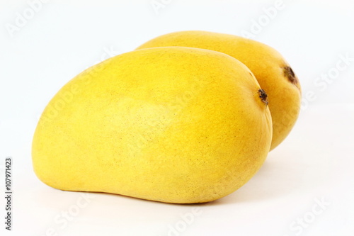 yellow mango fruit closeup isolated on white background