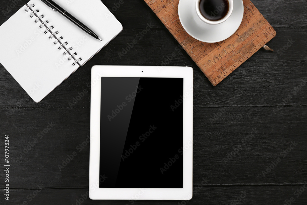 Digital tablet with cup of coffee and notebook on wooden table, closeup Digital tablet with cup of coffee and notebook on wooden table, closeup