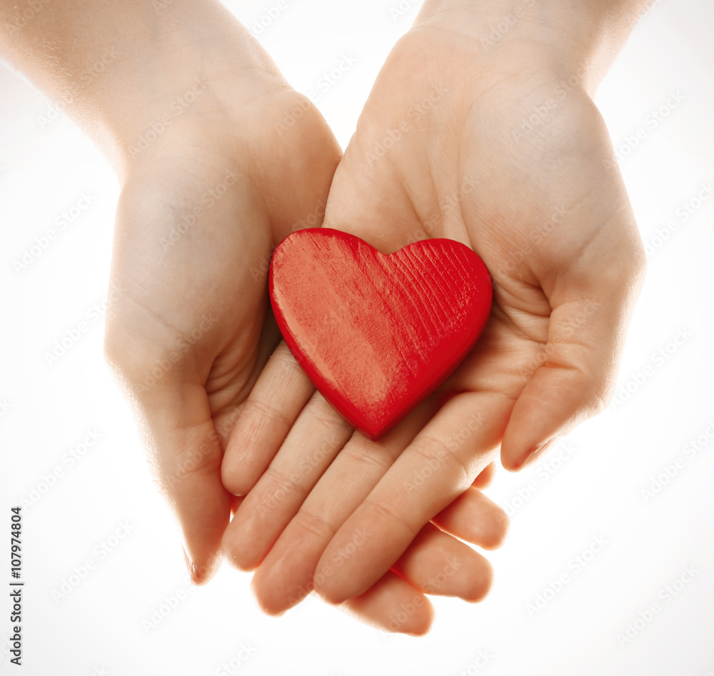 Obraz premium Decorative heart in female hands, isolated on white
