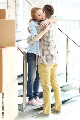 Happy young couple with mov...