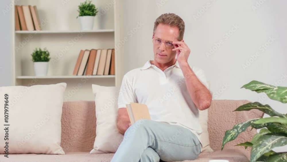 Pleasant man sitting on the couch Pleasant man sitting on the couch