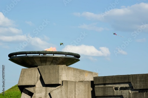 Fototapeta Naklejka Na Ścianę i Meble -  Kites fly over Eternal flame during celebration of Victory Day at the Museum of The History of Ukraine in World War II in Kyiv, Ukraine