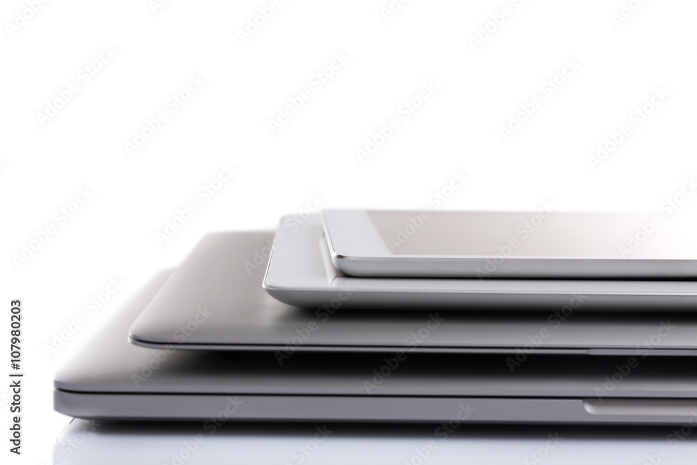 Stack of electronic devices on a white desk Stack of electronic devices on a white desk