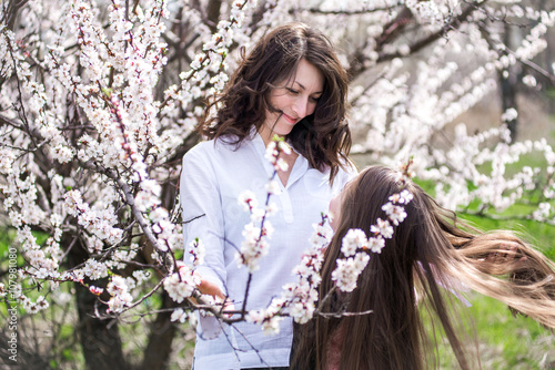 Mother and daughter walking in the garden