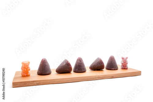 Cuberdons and sour bears on an plank photo