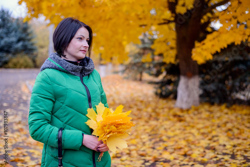 Cute young woman holding leaves and umbrella © Daddy Cool