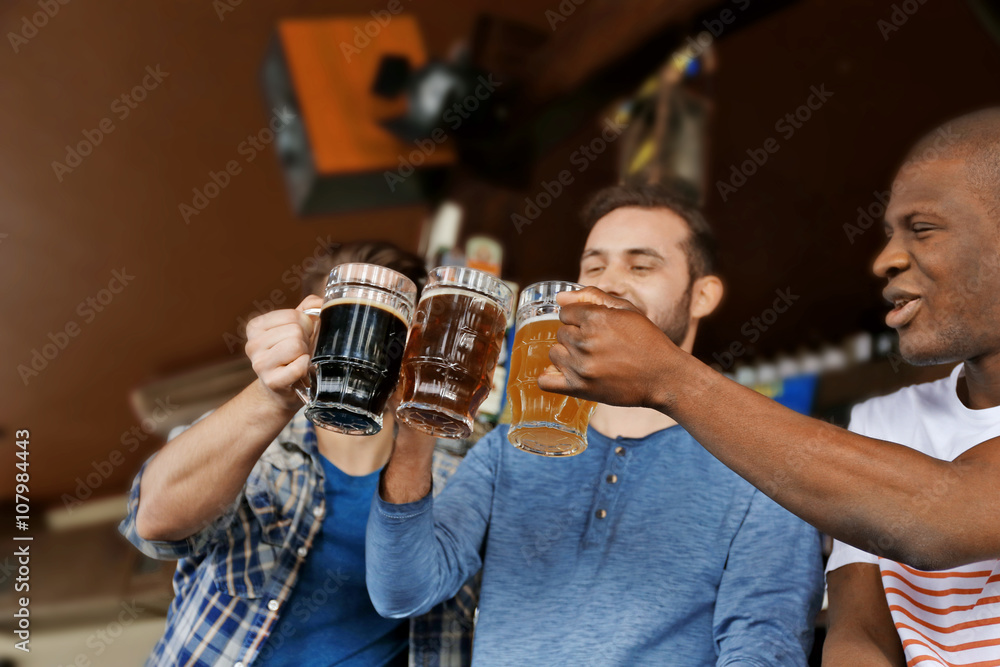 Group of happy friends drinking beer in pub Group of happy friends drinking beer in pub