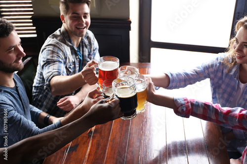 Group of happy friends drin...