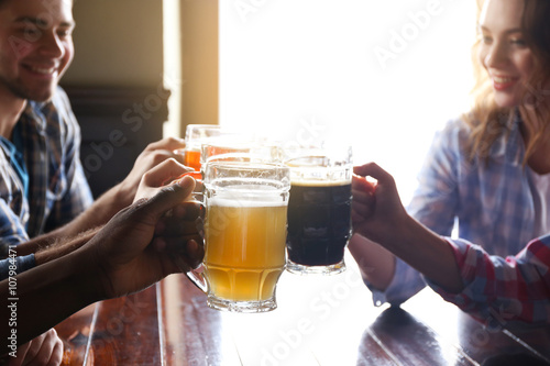 Group of happy friends drin...