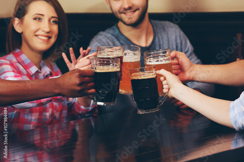 Group of happy friends drin...