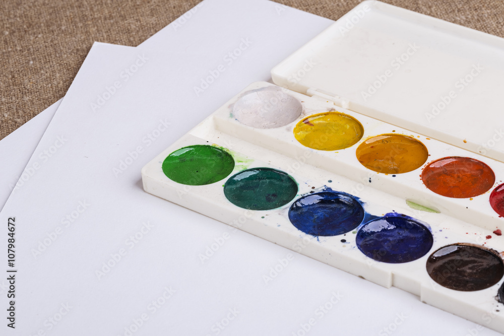 watercolor white palette and drawing paper on the table watercolor white palette and drawing paper on the table