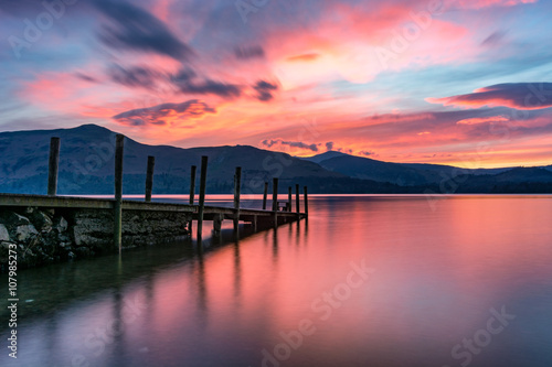 Print op canvas Beautiful pink and purple vibrant sunset with a jetty at Derwentwater, Keswick, Lake District, UK