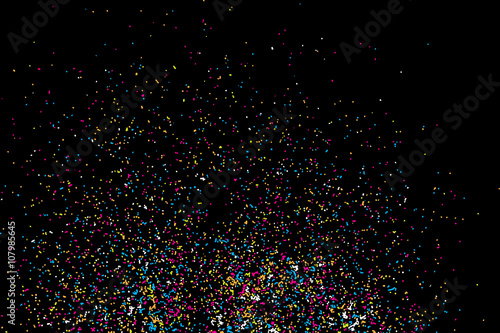 Colourful abstract grainy texture isolated on black background. Top view. Dust, sand blow spread on the flat surface or table.Paint drops or paint splashes graphic use. Design element.