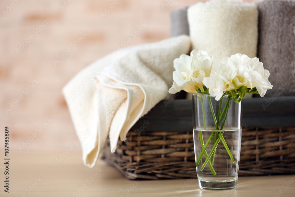 Towels and flowers on table