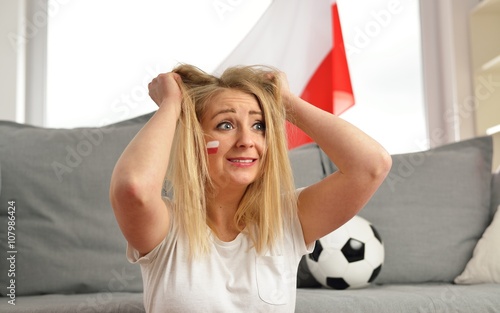 Polish fan cheers football team in the national colors.