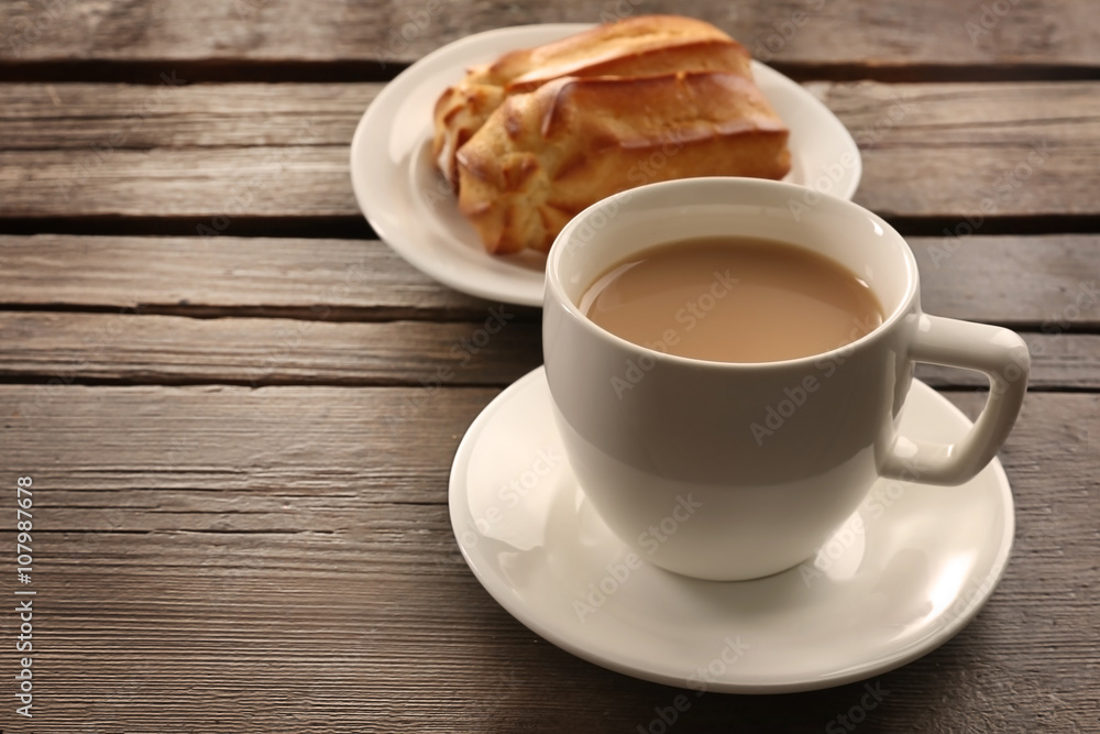 Fototapeta premium Milk tea with eclairs on wooden background.