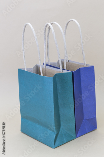 Paper blue and green shopping bag isolated on brown background