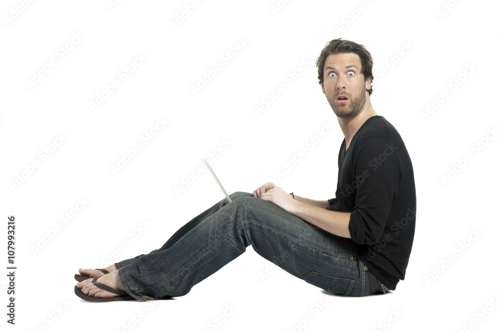 side view image of shocked man using a laptop side view image of shocked man using a laptop