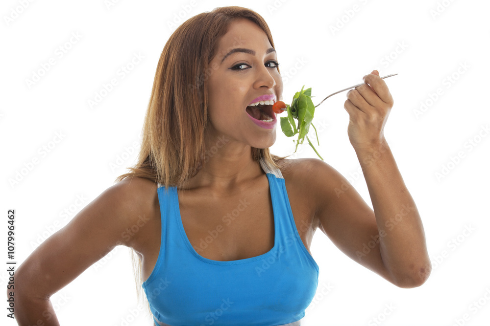 Pretty fit woman in a light blue sports bra having a healthy meal by eating a salad.
Shot on a white background. Pretty fit woman in a light blue sports bra having a healthy meal by eating a salad.
Shot on a white background.