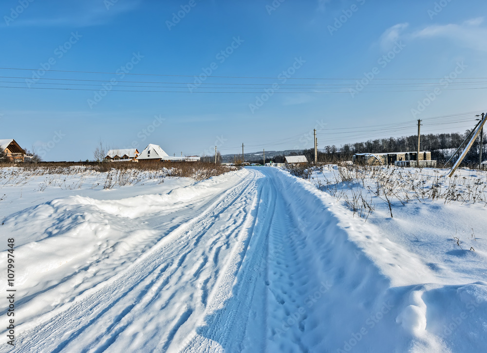 Snow-covered winter road in the village to Moscow area
