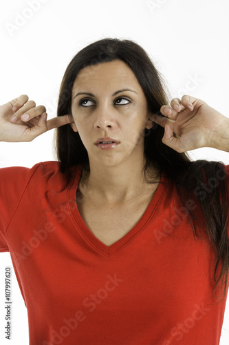 Woman with fingers in ears upset about the noise, Shot on a white background.
not listining
 photo