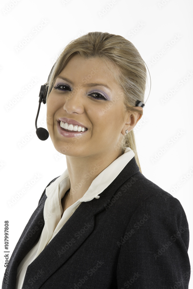 Woman in business suit talking on a headset, looking at camera smiling.
Woman in business suit talking on a headset, looking at camera smiling.