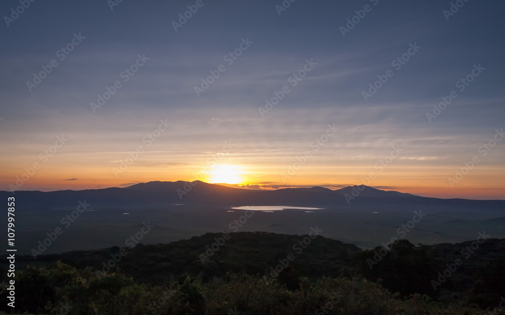 Panoramic view of huge Ngorongoro caldera (extinct volcano crater) with setting Sun against evening glow background at dusk. Great Rift Valley, Tanzania, East Africa.
Panoramic view of huge Ngorongoro caldera (extinct volcano crater) with setting Sun against evening glow background at dusk. Great Rift Valley, Tanzania, East Africa.