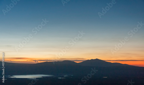 Panoramic view of huge Ngorongoro caldera (extinct volcano crater) with lake against evening glow background at dusk. Great Rift Valley, Tanzania, East Africa. 