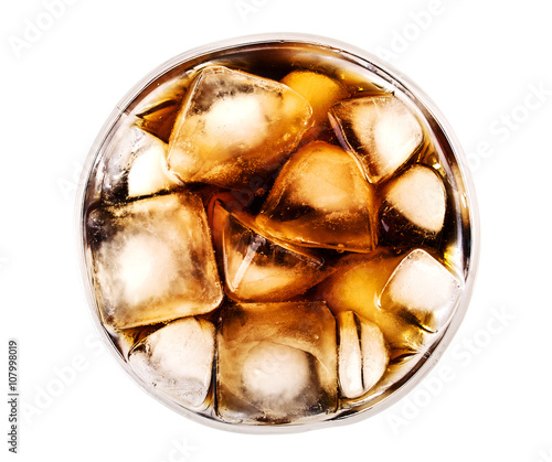 Cola in glass with ice from top on white background
