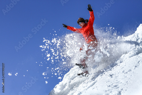 The girl jumps in a snowdrift
