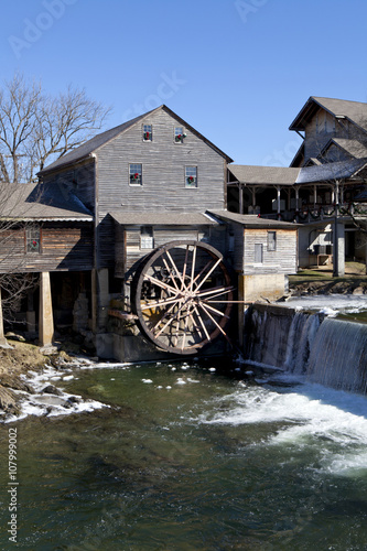 Watermill on the Little Pigeon river, in the mountain community of Pigeon Forge, Tennessee during the winter. Ice can be seen along the banks of the river
