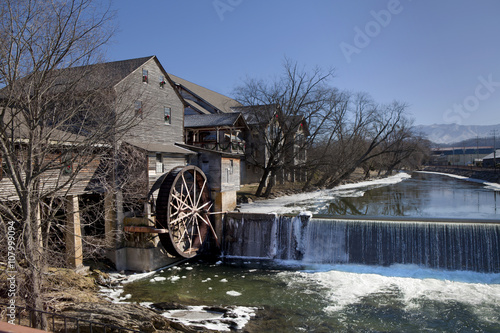 Watermill on the Little Pigeon river, in the mountain community of Pigeon Forge, Tennessee during the winter. Ice can be seen along the banks of the river 