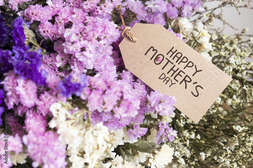 Bouquet of dried flowers with mothers day card on the wooden tab