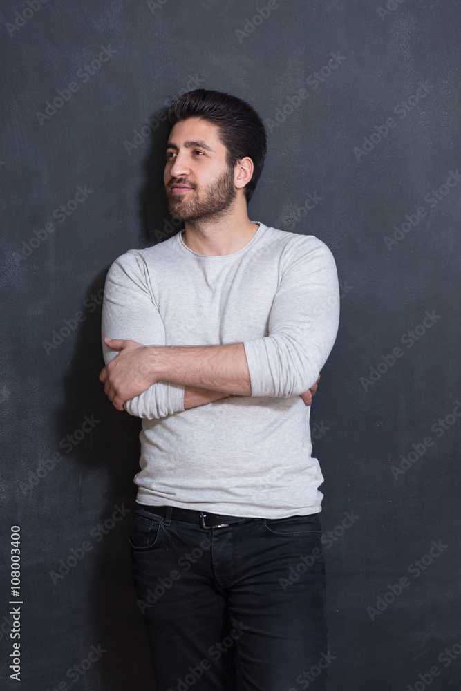 Handsome Young Man Smiling at the Camera Against chalkboard Wall Handsome Young Man Smiling at the Camera Against chalkboard Wall