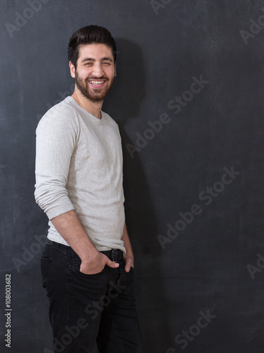 Studio picture of a young and handsome man posing on chalkboard © Myvisuals