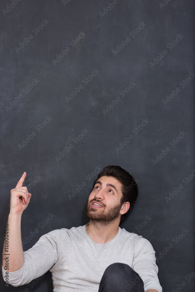 Handsome man with beard showing something on chalkboard, copy sp Handsome man with beard showing something on chalkboard, copy sp