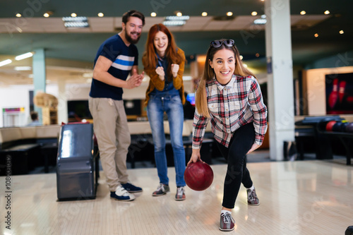 Friends having fun while bowling