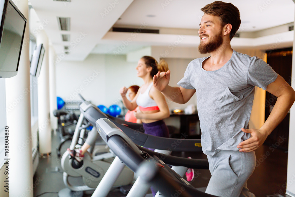 People running on treadmill in gym People running on treadmill in gym