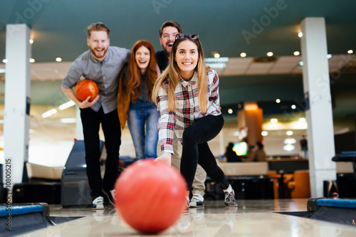 Friends having fun while bowling photo