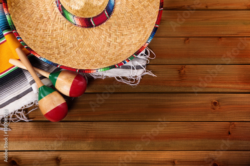 Mexico cinco de mayo old wood background mexican sombrero and maracas fiesta carnival photo
