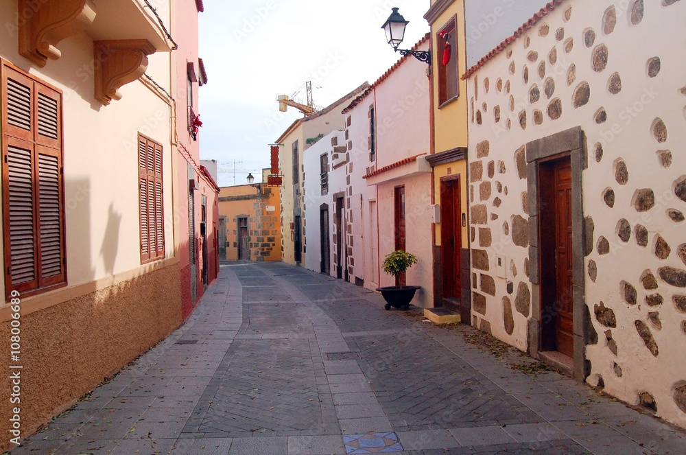 Fototapeta premium street with houses in soft pastel colors with wooden doors and s