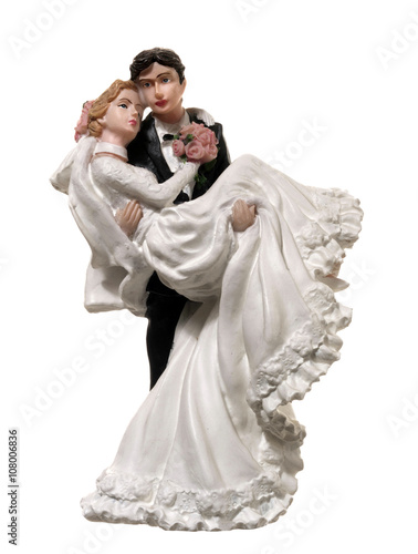 small figurines depicting bride in the arms of the groom
