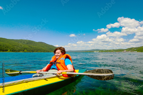 girl floats kayak on the river