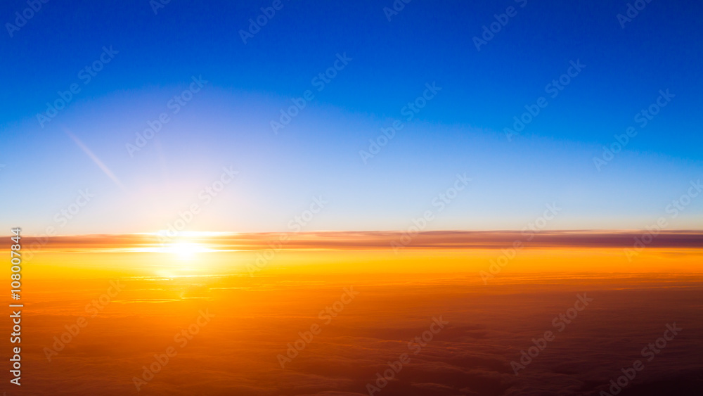Sunset scene. Sunset above the clouds
