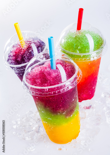 Frozen Rainbow Slush Drinks Chilling on Ice photo