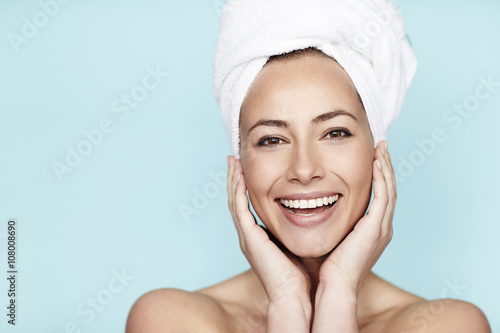 Smiling beautiful woman in towel, portrait