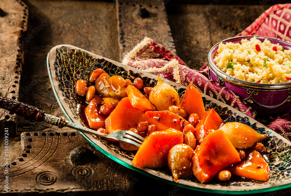 Tajine Vegetable Dish and Couscous on Wood Table