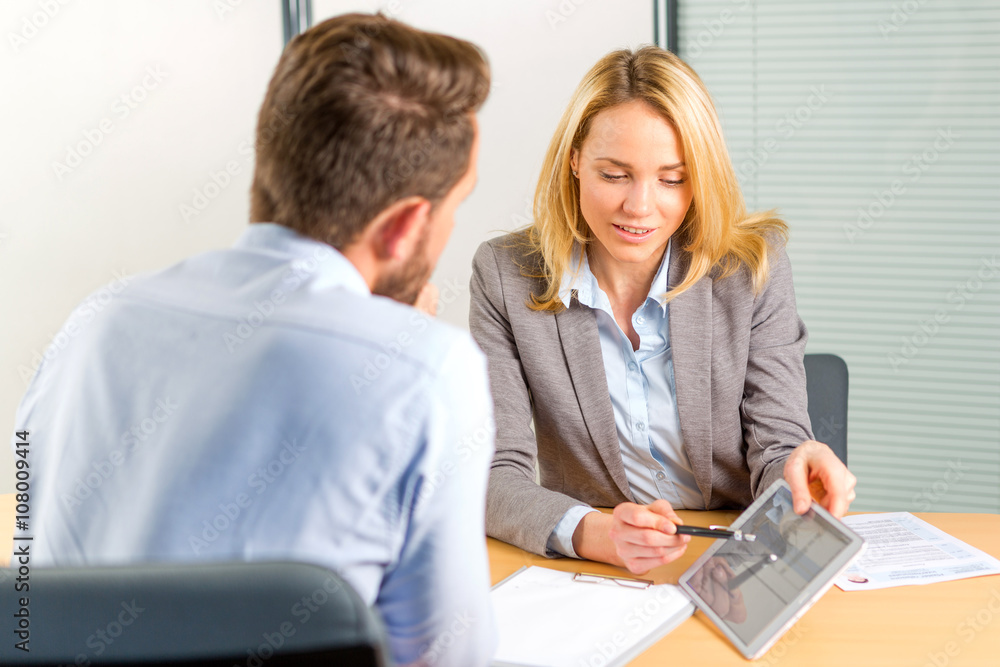 Young attractive woman during job interview using tablet Young attractive woman during job interview using tablet